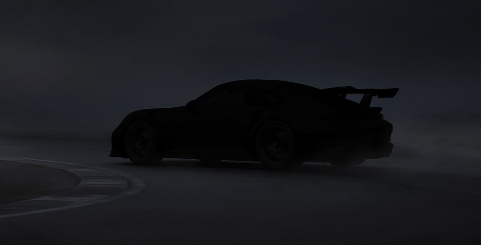 A blacked-out car on a misty circuit